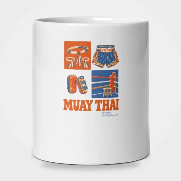 Mug blanc brillant imprimé d'une illustration vintage du mongkol, d'un short thaï, de paos et d'un coin de ring, au-dessus du titre « MUAY THAI » en lettres orange. – photo studio